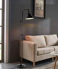Industrial Floor Lamp For Living Rooms And Bedrooms, Rustic Farmhouse Standing Reading Lamp With Adjustable Metal Heads beside a beige sofa.