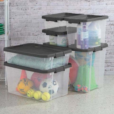 Modular Clear Box Stacker 30 Quart Storage System showing stackable plastic bins with gray lids, containing sports gear and cleaning supplies.