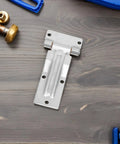 Heavy Duty Stainless Steel Trailer and Door Hinge With Silent Operation Triangle Hole Spacing 58x41mm installed on workbench