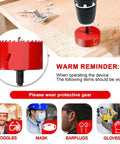 Hole saw 3-3/8 inch red, mounted on a drill over a wooden surface