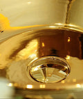 Close-up of the Premium Gold Ceramic Round Vessel Sink For Bathroom Countertop Vanity showing its sleek glaze and drainage hole.
