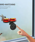 Set Of 2 Mini Glass Hummingbird Feeders With Window Mount Base For Handheld Or Tabletop Use Outdoors Holds 1 Oz Red And Yellow Flower Attractors For Grab And Go Bird Watching And Quick Feeding visible attached to window.