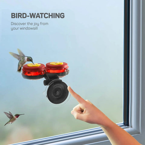Set Of 2 Mini Glass Hummingbird Feeders With Window Mount Base For Handheld Or Tabletop Use Outdoors Holds 1 Oz Red And Yellow Flower Attractors For Grab And Go Bird Watching And Quick Feeding visible attached to window.