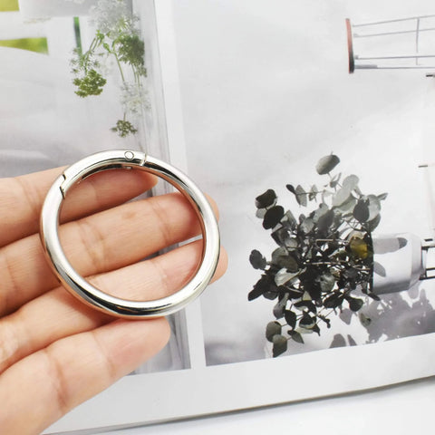 Person holding 10 Pcs Big Round Carabiner Clips, 2 Inch, 50 Mm, Metal Trigger Snap Hooks With O Rings For DIY Charms, Keychains, Bags