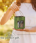 Person holding a Green Kraft Paper Gift Bag with handles and clear window, medium size, showing contents for kids' party gifts.