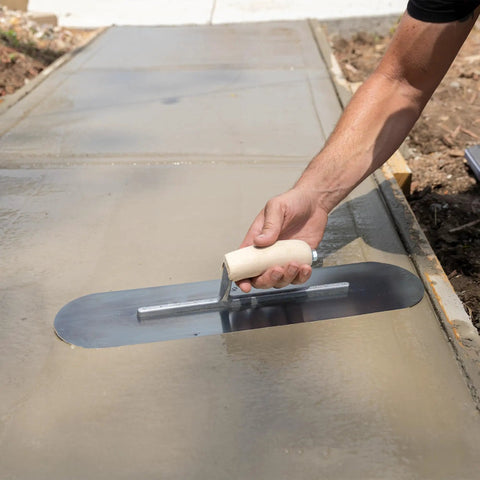 Using Pool Trowel With 20 Inch Blue Steel Blade Flexible For Radius Finishes on wet concrete surface