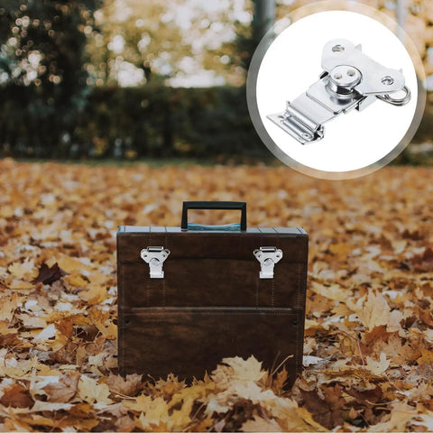 Spring Loaded Butterfly Latches Three Piece Set Stainless Steel on brown wooden toolbox surrounded by autumn leaves