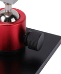 Close-up of red and black base of Small Table Vise Clamp With 0-2.48 Inch Grip, 360 Degree Rotatable Workbench Vise for Jewelry Making.