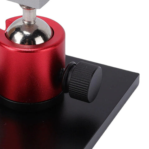 Close-up of red and black base of Small Table Vise Clamp With 0-2.48 Inch Grip, 360 Degree Rotatable Workbench Vise for Jewelry Making.