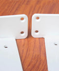 Set Of 2 11 Inch White Hidden L Shelf Brackets Heavy Duty Floating Shelf Brackets on wooden surface