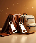 Two Pack Gold Zipper Pull Replacement Sliders for luggage with backpack, leather fabric backdrop