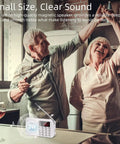 Elderly couple dancing in the kitchen with Tiny But Mighty Ultra Compact AM FM Pocket Radio visible on the countertop.