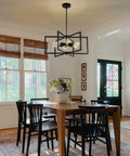 Drop-Dead Gorgeous 23.6 Inch Black Farmhouse Chandelier With Six Lights And Fully Adjustable Drop For Kitchen Table Dining Room Or Foyer illuminating a dining table.