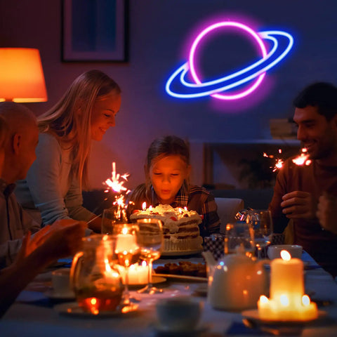 Planet Neon Sign LED Neon Light Sign for Wall Decor USB Powered in a family birthday scene with candles and cake.