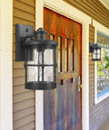 Outdoor Wall Sconces Dusk To Dawn Black Finish Seeded Glass Exterior Wall Mount Lighting 2 Pack on porch by wood door