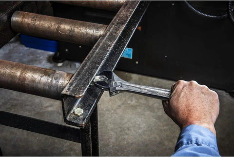 Using Six Inch Adjustable Wrench With Bagged Packaging, Hex Jaw Design for slip-free gripping on metal fastener in the garage.