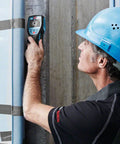 User operating the Road Ready 5 In 1 Wall Scanner And Electronic Stud Sensor against a concrete wall.