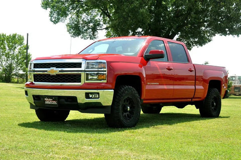 Red Chevy Silverado equipped with 2 Inch Red Aluminum Leveling Kit For Chevy And GMC 1500 2007 To 2018 Level Front To Rear