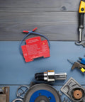 Slick Automatic Aerosol Fire Extinguisher With Smart Sensor Detection on a workbench surrounded by tools and equipment.