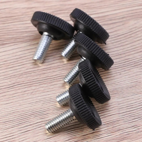 Badass Heavy Duty Adjustable Furniture Levelers With Tee Nuts Kits Black Steel And Rubber Pads For Killing Wobble On Cabinets Tables Chairs Workbenches Quick Setup close-up of black rubber topped leveler feet with threaded steel shafts on wood background