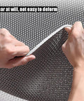 Hella Tough Non Slip Pvc Floor Mat, Cuttable Poolside Runner For Garage And Commercial Spaces, showing hands gripping the flexible mat's edge.