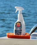 Marine Quick Wax Spray For Boats With Fiberglass And Gelcoat Easy Spray On Application Delivers Slick Gloss Finish On Wet Or Dry Surfaces 90 Day Protection And Quick Shine For A Fresh Look 32 Oz bottle on boat with water background