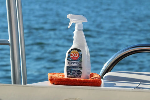 Marine Quick Wax Spray For Boats With Fiberglass And Gelcoat Easy Spray On Application Delivers Slick Gloss Finish On Wet Or Dry Surfaces 90 Day Protection And Quick Shine For A Fresh Look 32 Oz bottle on boat with water background