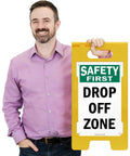 Drop Off Zone Floor Sign 25 By 12 Inches Two Sided Folding A Frame Tough As Nails Durable Polypropylene Plastic Double Sided Visibility Easy Carry Handle Digitally Printed Made In USA shown with safety first drop off zone text