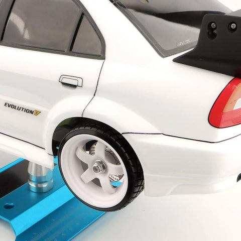 Back view of a white RC car with 1/10 scale RC drift tires and 12mm hex hub, mounted on a blue stand for on-road drifting.