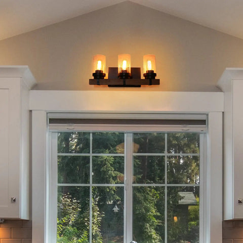 Three Light Dope Vintage Wood Wall Mount Sconce With Bubble Glass Shade above window, Edison Style E26 bulbs lit.