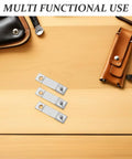 Three Six Pack Mechanical Clock Suspension Springs Universal 17mm Replacement Parts on wooden surface with leather case nearby.