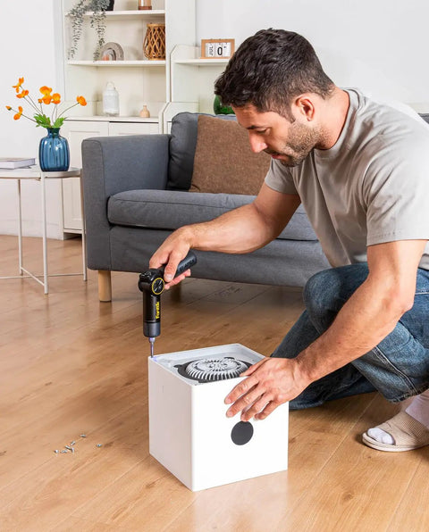 High Performance Pivot Handle Electric Screwdriver Featuring Live Torque Display And Eight Adjustable Settings For Hustle Ready Tech Repairs And Smooth Jobs being used by man on white box fan.