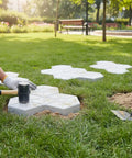 Person installing Leaf Pattern Concrete Paver Mold For Pathways And Patios Reusable Stone Garden Mold DIY Landscape Paving Tool on grass.
