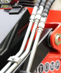Close-up of hydraulic lines on Stomp Mini Skid Steer Loader With 1800 Lb Capacity And Lawn Scarifier Attachment For Small Jobs.