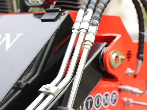 Close-up of hydraulic lines on Stomp Mini Skid Steer Loader With 1800 Lb Capacity And Lawn Scarifier Attachment For Small Jobs.