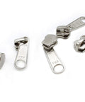 Zip Repair Kit With Metal Aluminum Sliders And Top And Bottom Stops, Assorted Sizes 3, 4.5, 5, And 10 displayed on white surface