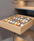 Heavy Duty Pull Out Cabinet Drawer Made From Solid 9 Ply Baltic Birch With Dovetail Joints showcasing spices organized in a kitchen.