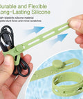 Person using 24 Piece Silicone Cable Ties Pack With Locking Buckles Reusable And Washable Adjustable Straps For Cable Management No Fuss Multi Purpose High Elasticity Cord Organizer In Four Colors