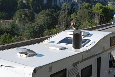 RV rooftop with installed Long Range 915MHz LoRa Antenna With Magnetic Base, SMA Male Connector visible, surrounded by trees and road.