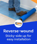 Person unrolling Blue Self Adhesive Floor Protection Film For Moving And Construction Projects on hardwood floor