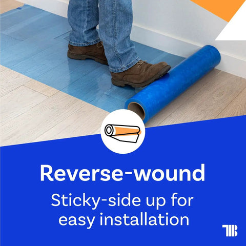 Person unrolling Blue Self Adhesive Floor Protection Film For Moving And Construction Projects on hardwood floor