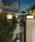 Chill Out In Style With These Modern Warm Led Post Cap Lights That Deliver Luxury Waterproof Vibes Perfect For All Your Fence Deck Garden And Patio Posts E26 Bulb Ready For Awesome Outdoor Living, illuminating a modern fence at night.