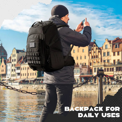 Man wearing Tactical Backpack For Men 40L Water Resistant With Molle System For Hiking Camping And Gym by a waterfront