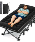 Extra Wide 32 Inch Camping Cot With Thick Mattress Holds Up To 600 Lbs; person lying on black camping cot showing stability and comfort
