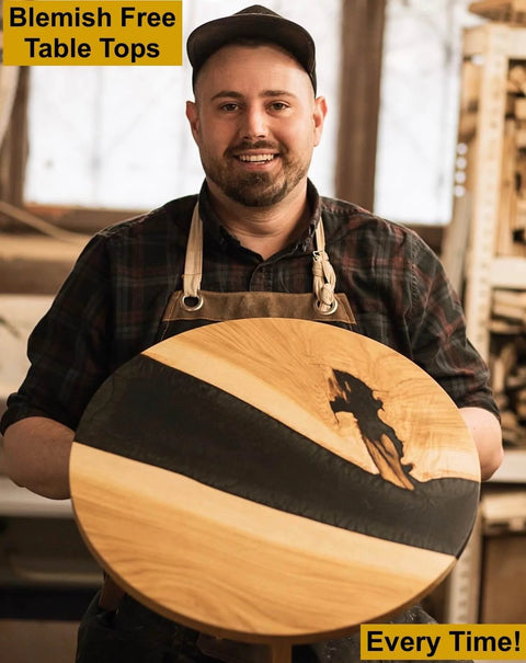 Craftsman holding a round wooden tabletop cut with Blemish Free Pivot Plate for flawless discs and tabletops, clean edges visible.