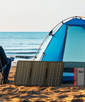 Grey red Portable Power Bank With AC Outlet 65W External Battery for RV camping next to tent and solar panel on beach