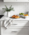 Stainless Steel Cabinet Pulls With Brushed Silver Finish, visible on sleek kitchen drawer with marble countertop and croissants.