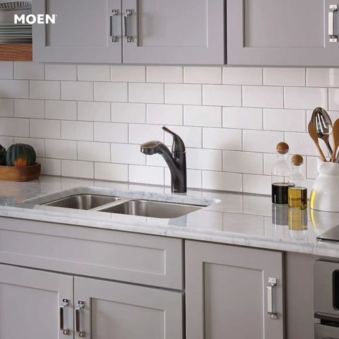 Brecklyn Mediterranean Bronze Single Handle Pull Out Sprayer Kitchen Faucet With Power Clean Tech installed on white tiled backsplash