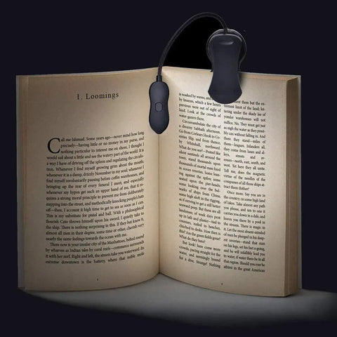 Rechargeable Clip On LED Book Light With Warm Natural Cool White Colors And Nine Brightness Levels For Eye Care Reading Up To 60 Hours Lightweight Portable Ideal For Bookworms illuminating an open book.