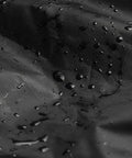Close-up of Waterproof Outdoor Stackable Chair Cover for Patio Chairs 210D Heavy Duty Fabric with water droplets, black color
